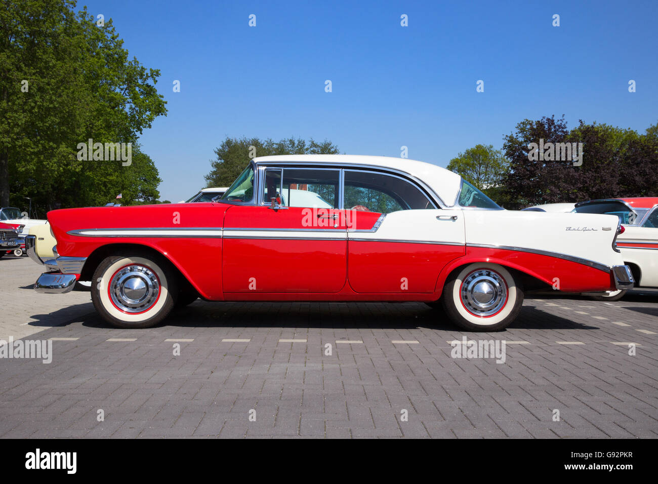 Side view of a parked red and white 1956 Chevrolet Belair 4-door hardtop Stock Photo