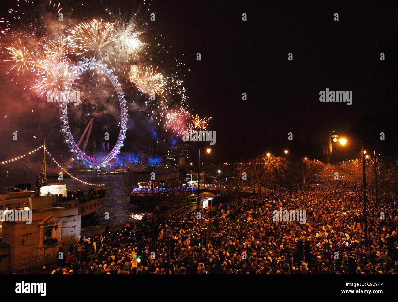 Fireworks engulf the London Eye in central London to call in the New Year. Stock Photo