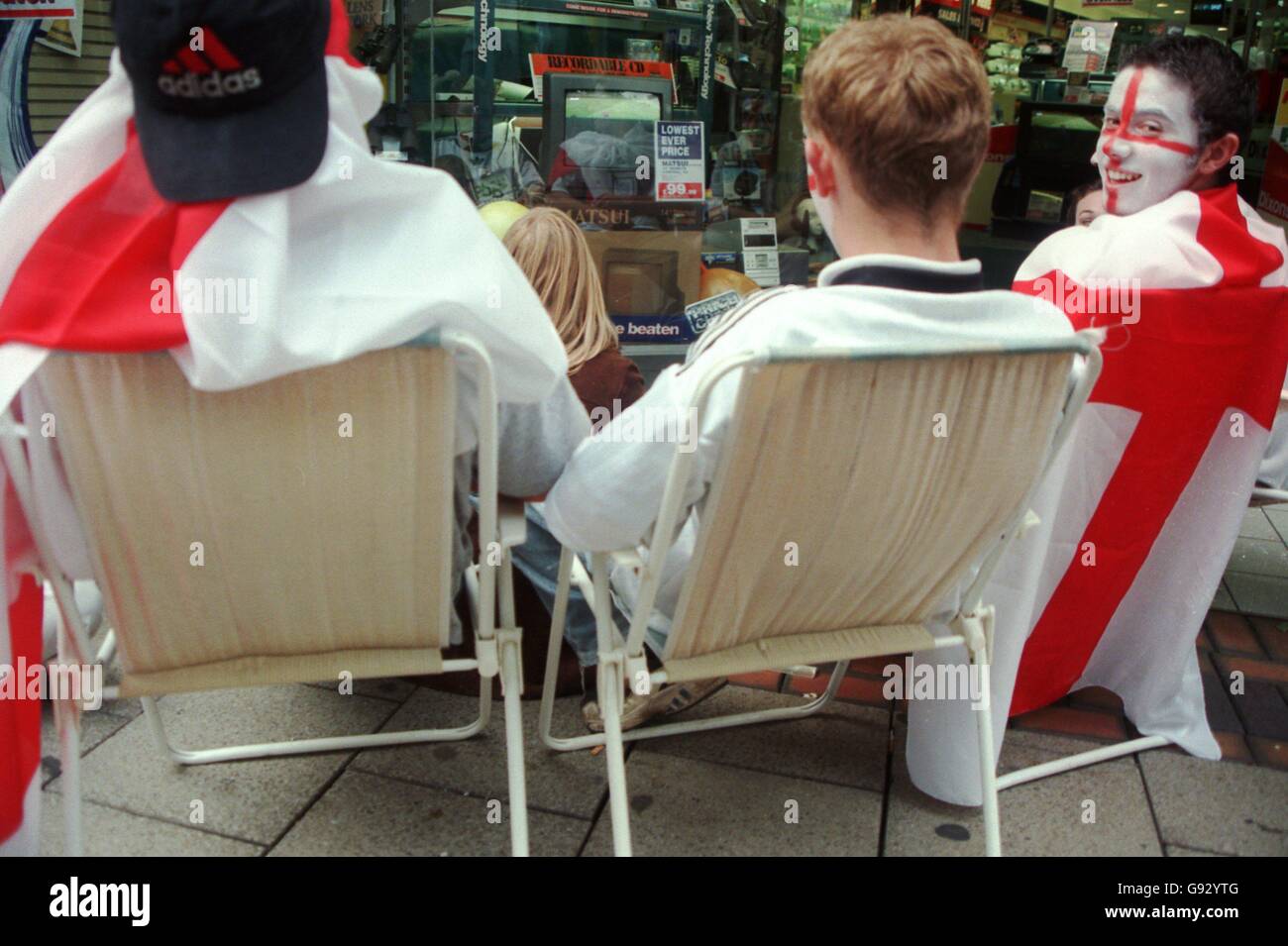England fans in Nottingham watch the game on television through a shop window Stock Photo