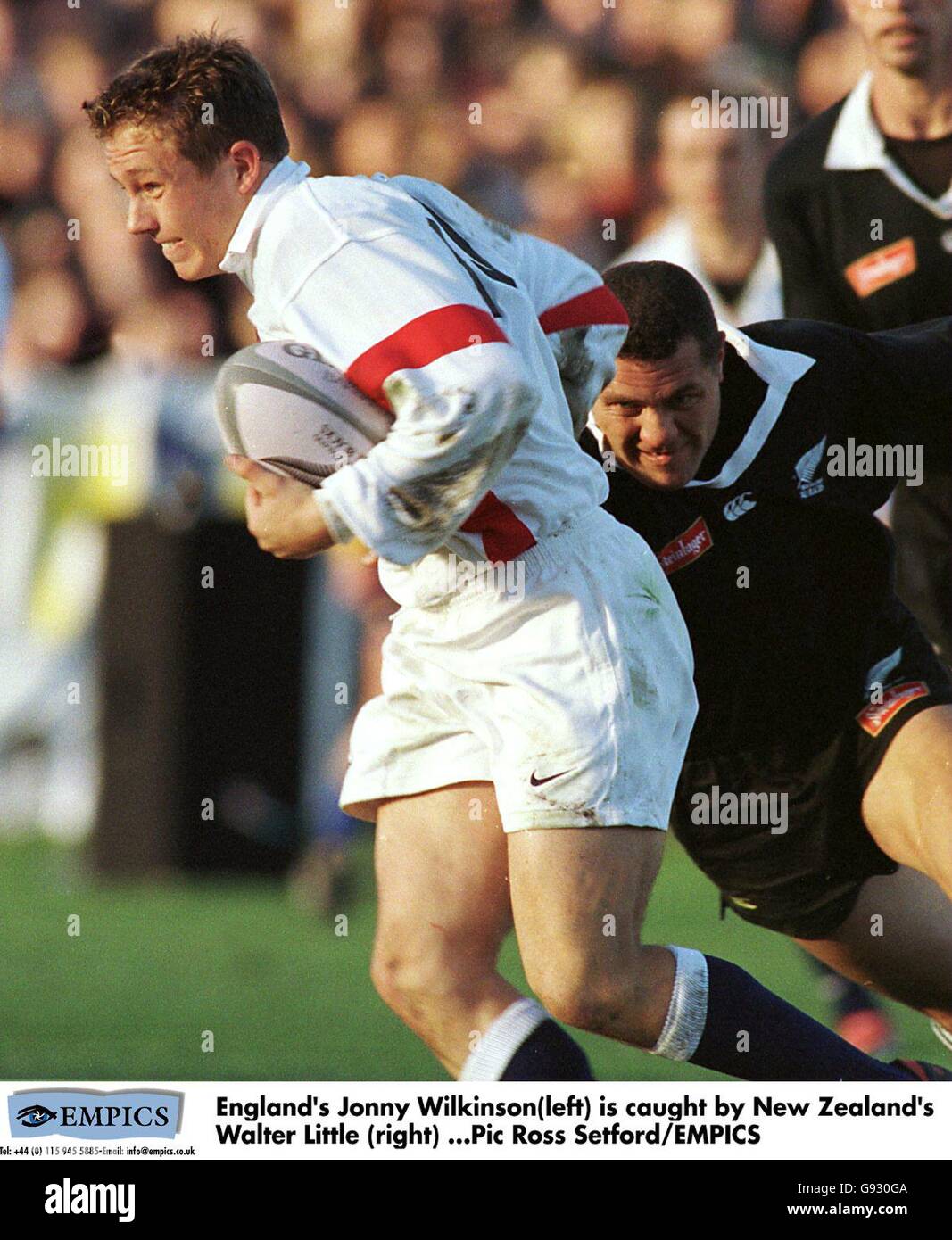 England's Jonny Wilkinson(left) is caught by New Zealand's Walter ...