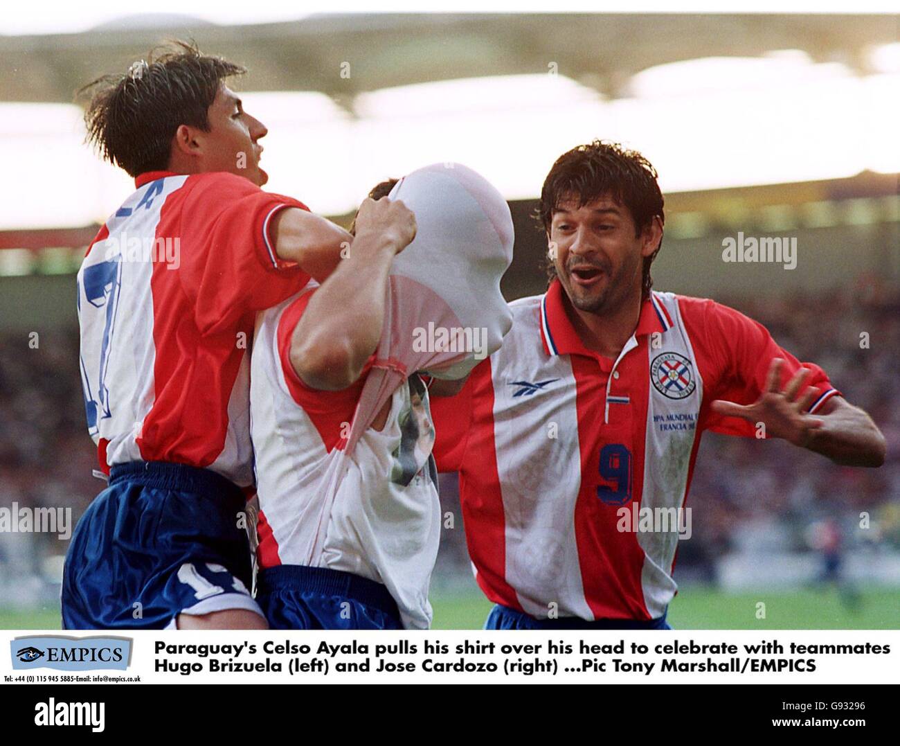 Paraguay's Celso Ayala (centre) pulls his shirt over his head to celebrate scoring the opening goal with teammates Hugo Brizuela (left) and Jose Cardozo (right) Stock Photo