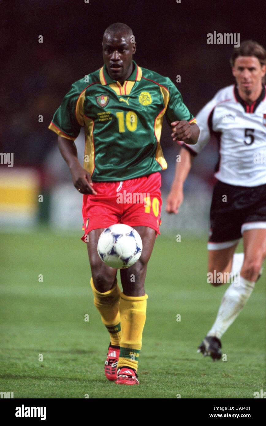 Cameroon's Patrick Mboma (left) gets away from Austria's Wolfgang Feiersinger (right) Stock Photo