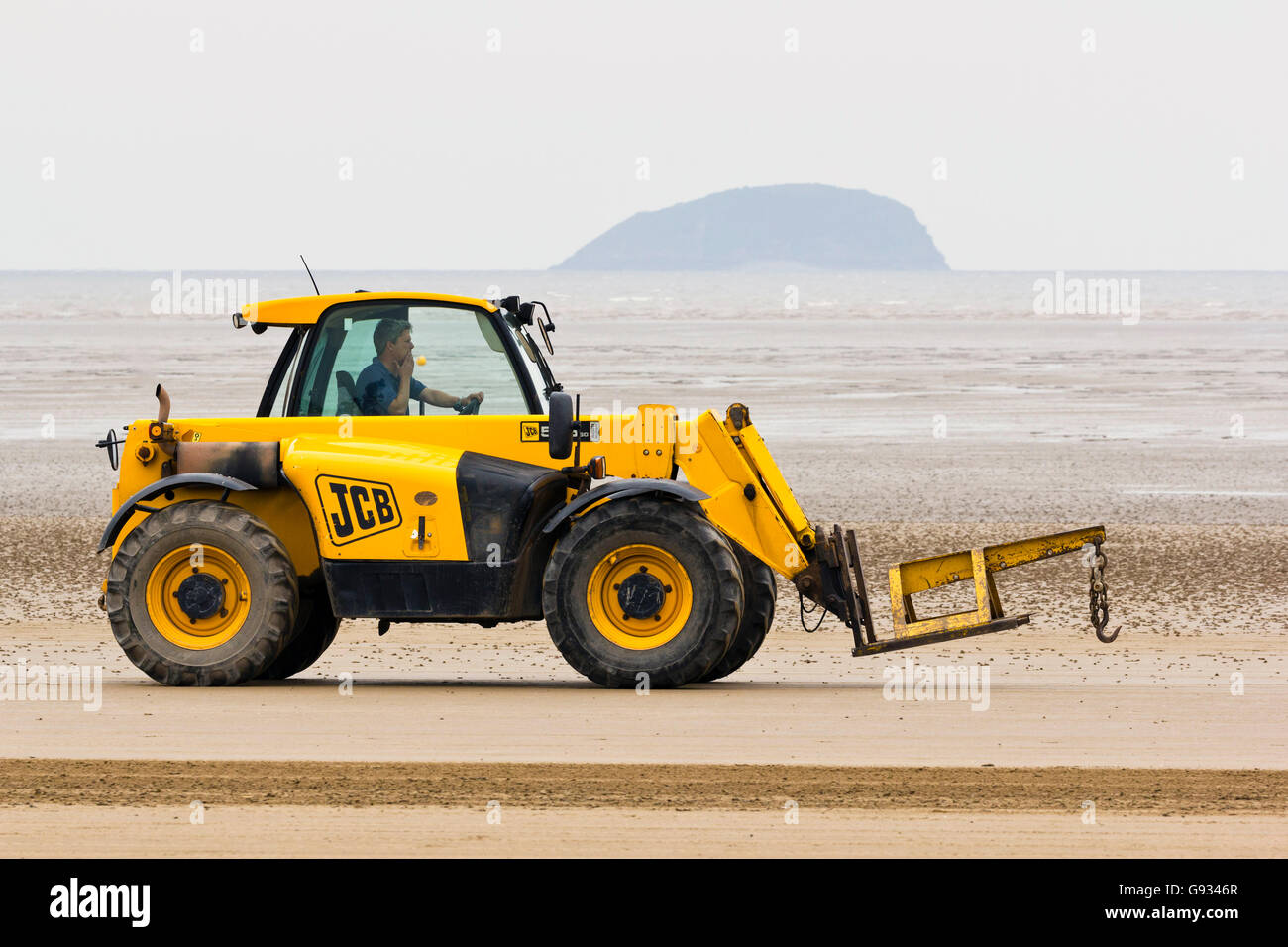 A JCB driving along the beach during the Weston Air Festival, 18th June 2016. Stock Photo