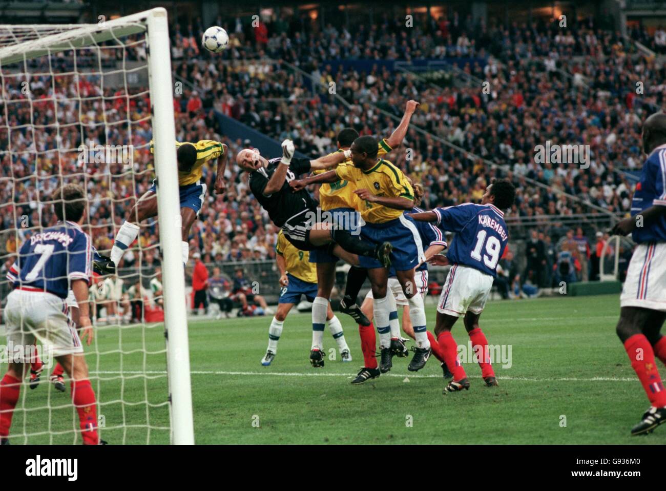 France goalkeeper Fabien Barthez (third left) is fouled by Cesar Sampaio of Brazil (third right) as Rivaldo of Brazil (second left) jumps up to head the ball Stock Photo