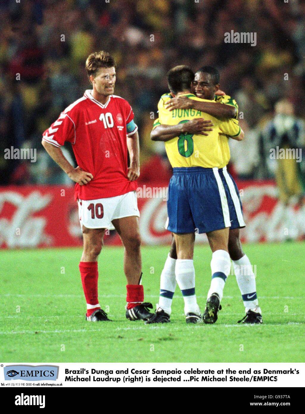 Brazil's Dunga (centre) and Cesar Sampaio (right) celebrate at the end of the game as Denmark's Michael Laudrup (right) is dejected Stock Photo