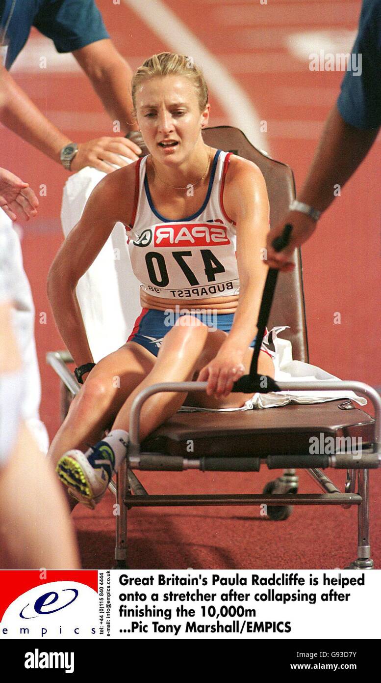 Athletics - 17th European Championships - Budapest. Great Britain's Paula Radcliffe is helped onto a stretcher after collapsing after finishing the 10,000m Stock Photo