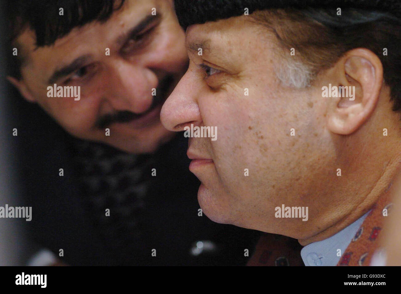 An unidentified man stands near former Prime Minister of Pakistan Nawaz Sharif (front) inside Baylis House in Slough, Berkshire, Sunday January 29, 2006. Mr Sharif flew into Britain this evening from Saudi Arabia where he has been in exile for the past five years. Mr Sharif was ousted from power during a military coup in Pakistan in October 1999. Watch for PA story POLITICS Sharif. PRESS ASSOCIATION photo. Photo credit should read: Johnny Green/PA. Stock Photo