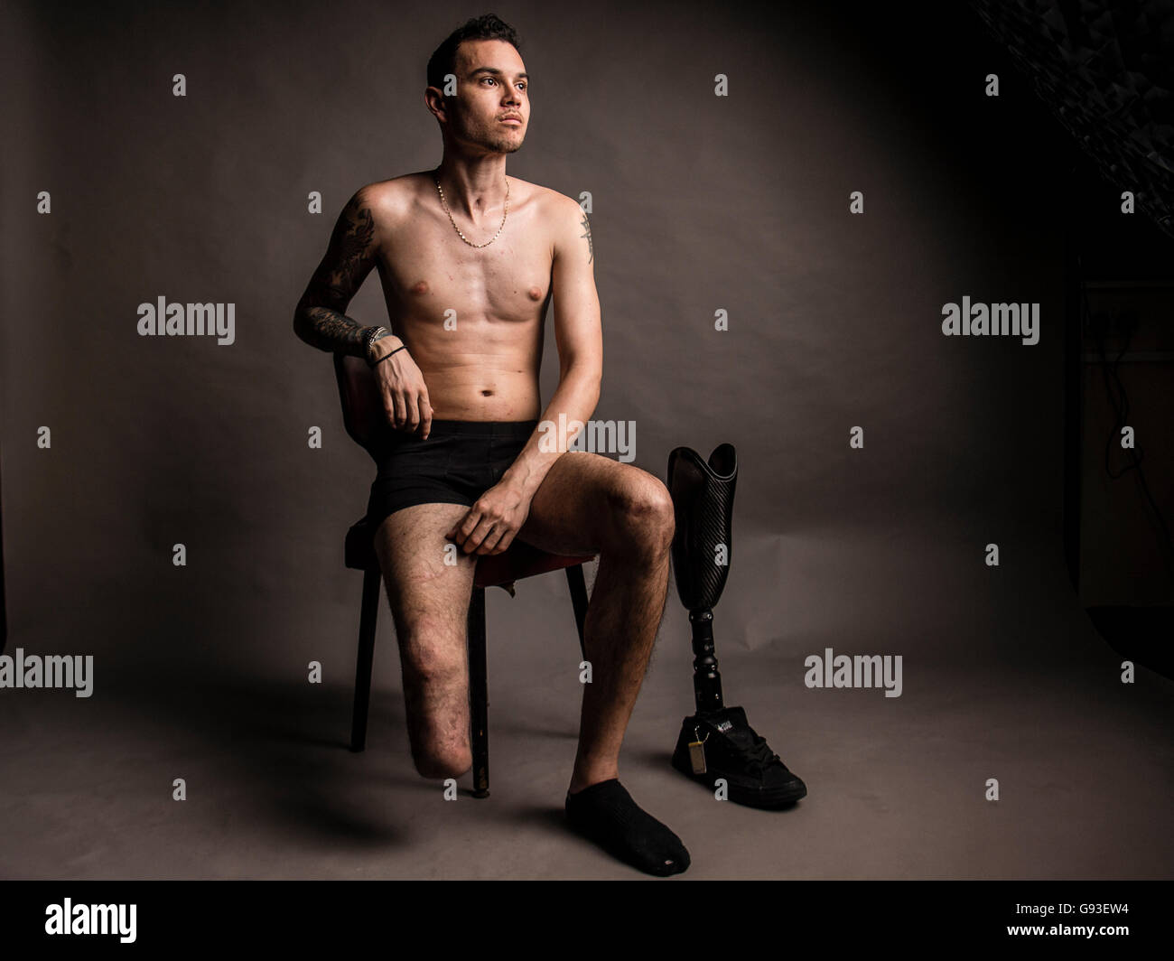 Jay, who has had his right leg amputated below the knee after a car  accident, with his prosthetic leg and foot. Studio portrait photography. UK  Stock Photo - Alamy