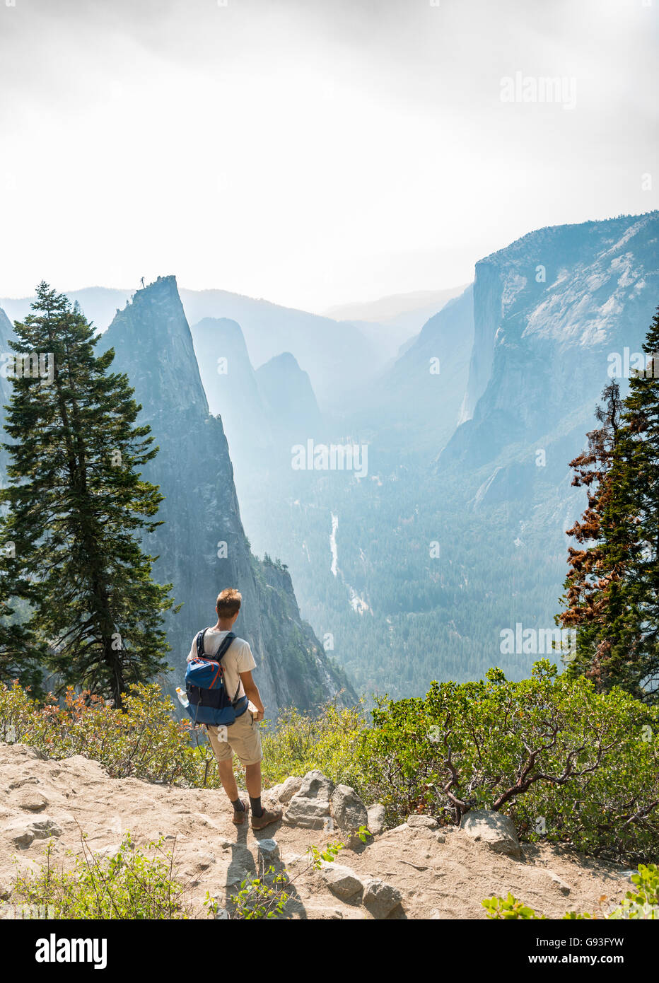 Young man on hiking trail, view of Yosemite Valley, Four Mile Trail, Taft Point, El Capitan, Yosemite National Park, California Stock Photo