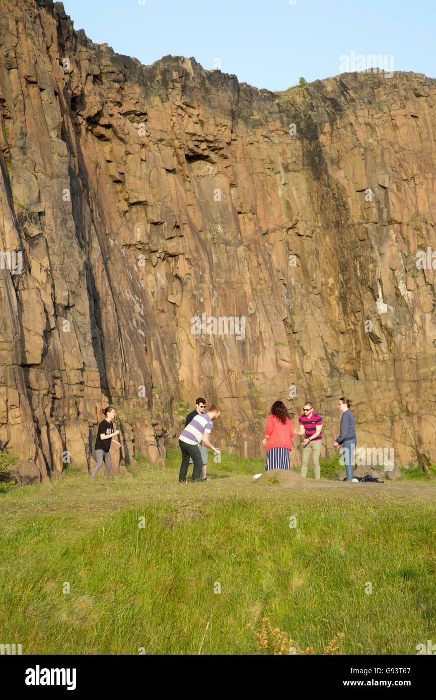 People Playing on Salisbury Crags, Holyrood Park, Edinburgh, Scotland Stock Photo