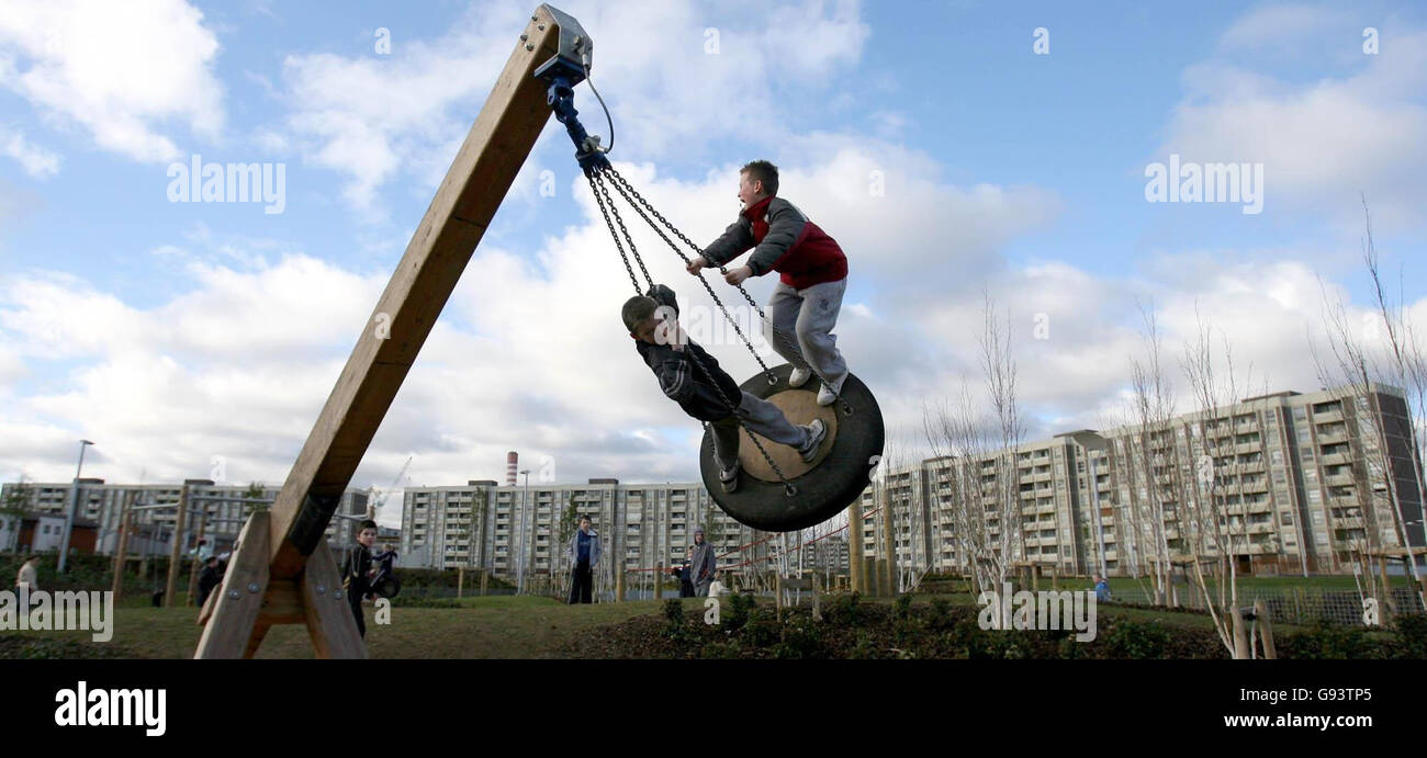 Two young boys swing high over Ballymun flats in the Coultry Neighbourhood Park, Dublin, which was opened by housing and urban renewal minister Noel Ahern, Saturday January 28, 2006. PRESS ASSOCIATION photo. Photo credit should read: Niall Carson/PA. Stock Photo
