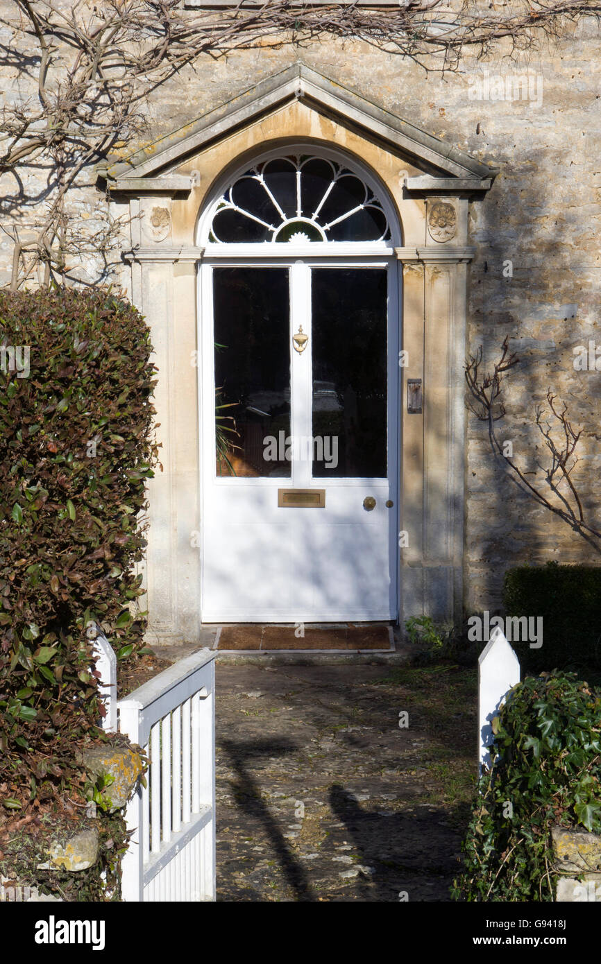 UK. A classical style front door in white  with a portico. Stock Photo