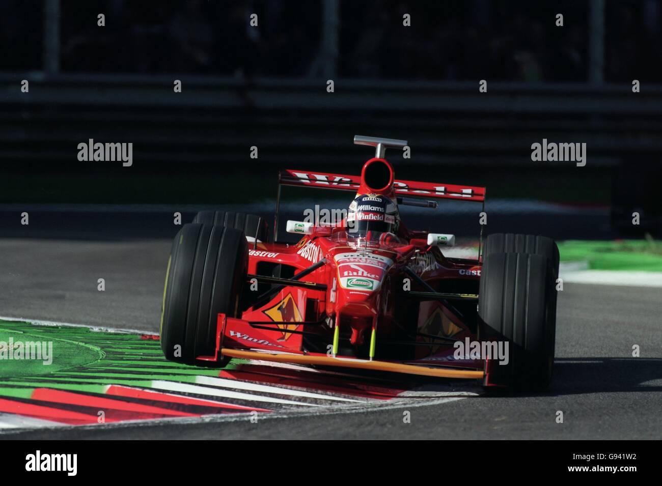 Williams driver Heinz-Harald Frentzen uses the full width of the kerbs at Monza Stock Photo