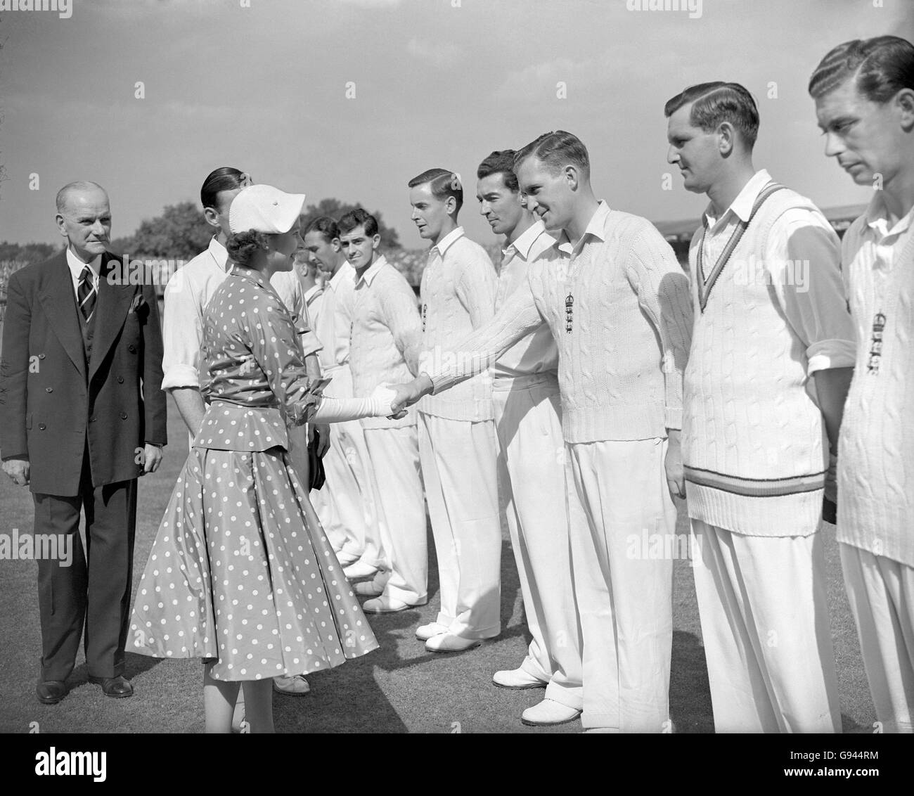 HRH Queen Elizabeth II (l) shakes hand with England's Jim Laker (third r) as England captain Len Hutton (l, hidden) introduces his team before the start of the day's play Stock Photo