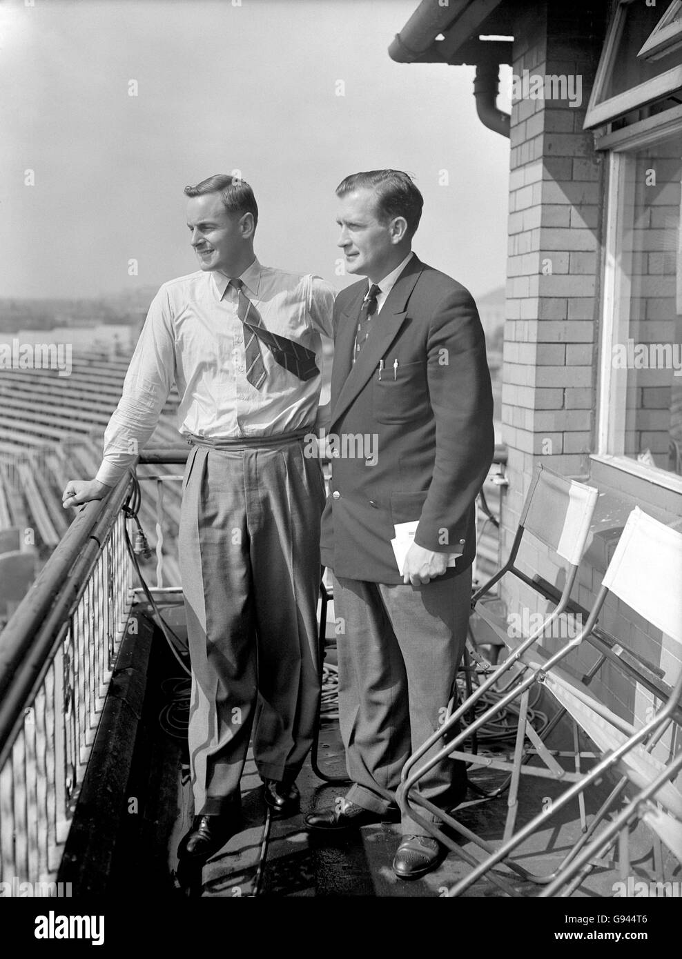 Cricket - The Ashes - Fourth Test - England v Australia - Old Trafford - Third Day. England's Peter May (l) and Jim Laker (r) look forward to the third day's play from the dressing room balcony Stock Photo