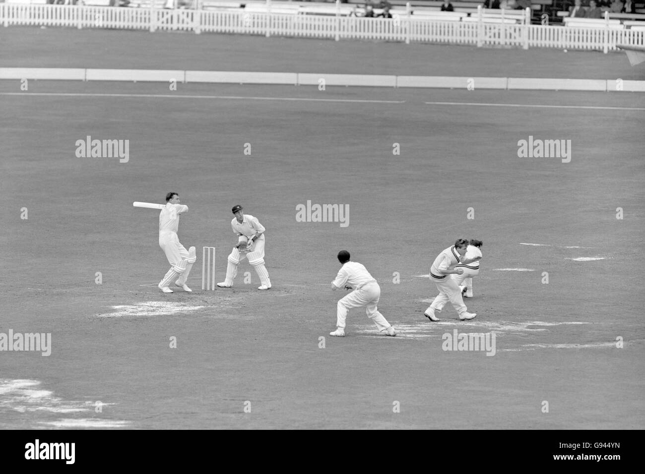 Cricket - County Championship - Middlesex v Surrey - Lord's - Third Day. Middlesex fielders take cover as Surrey's Jim Laker (l) pulls the ball to the boundary for four Stock Photo
