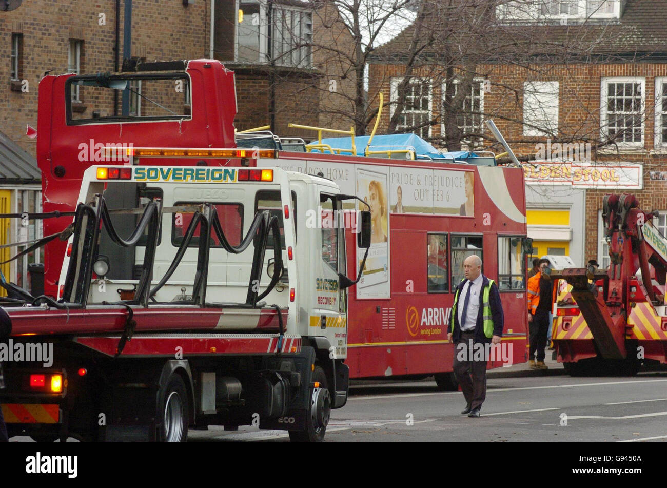 A bus is prepared to be towed away by a recovery vehicle after crashing into a tree on Tottenham High Road in north-east London, Monday February 13, 2006. The collission led to the upper deck of the double-decker bus being ripped off. Two people were sitting on the top deck of the number 349 bus at the time. They were not seriously injured. The bus driver was taken to hospital believed to be suffering from shock. See PA story POLICE Bus. PRESS ASSOCIATION Photo. Photo credit should read: Johnny Green/PA. Stock Photo