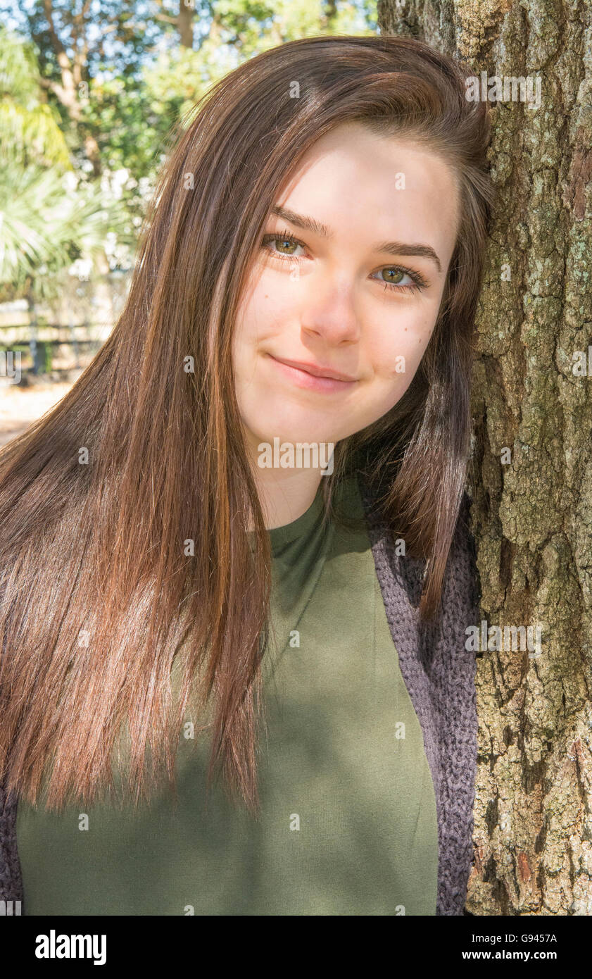 young teenage girl age 15 testimonial portrait with tree happy teen  Model Released, MR-2 Stock Photo