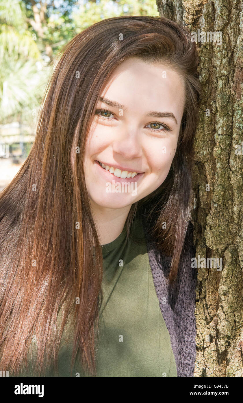 young teenage girl age 15 testimonial portrait with tree happy teen  Model Released, MR-2 Stock Photo