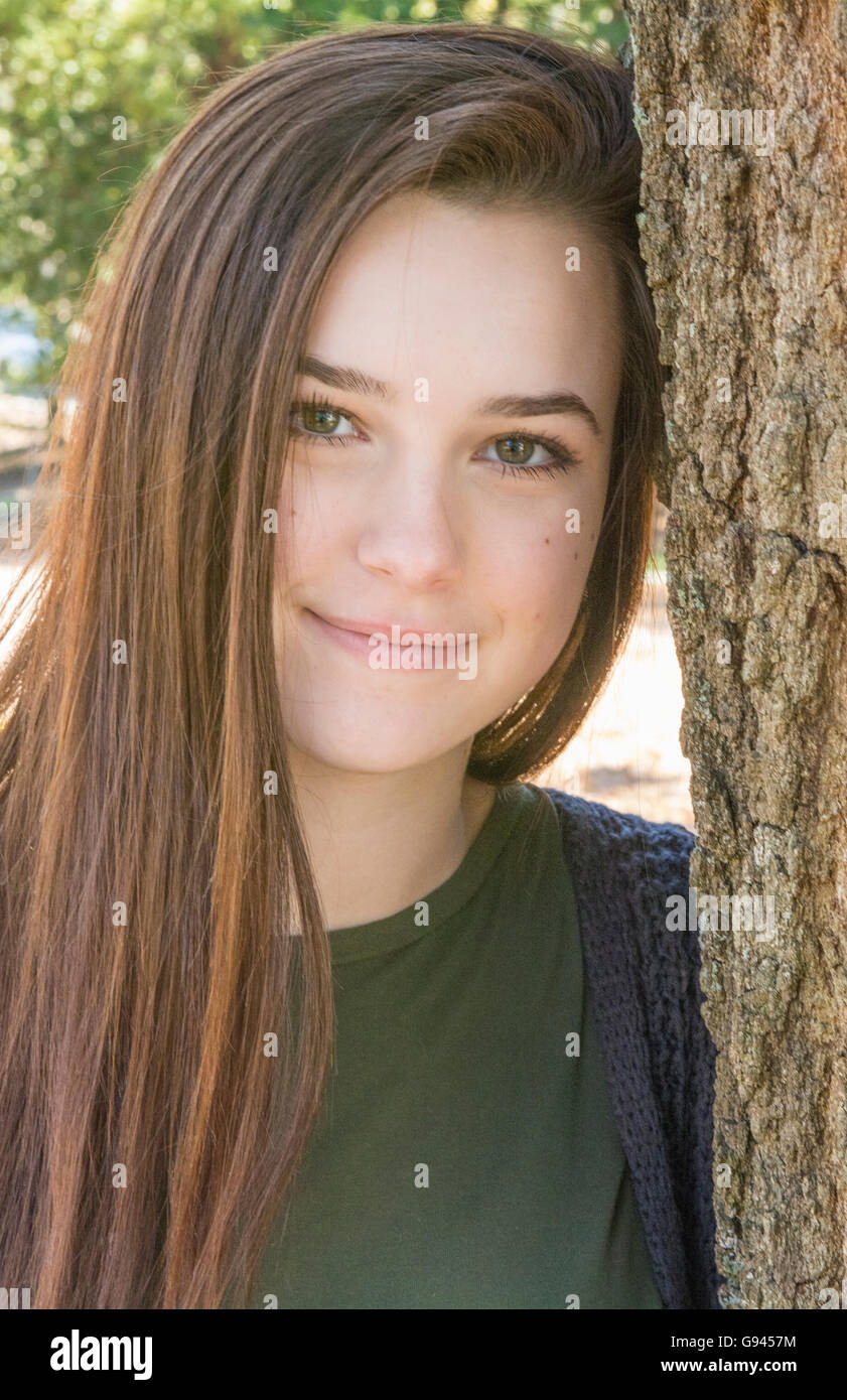 young teenage girl age 15 testimonial portrait with tree happy teen  Model Released, MR-2 Stock Photo