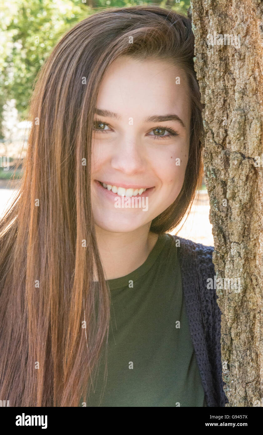 young teenage girl age 15 testimonial portrait with tree happy teen  Model Released, MR-2 Stock Photo