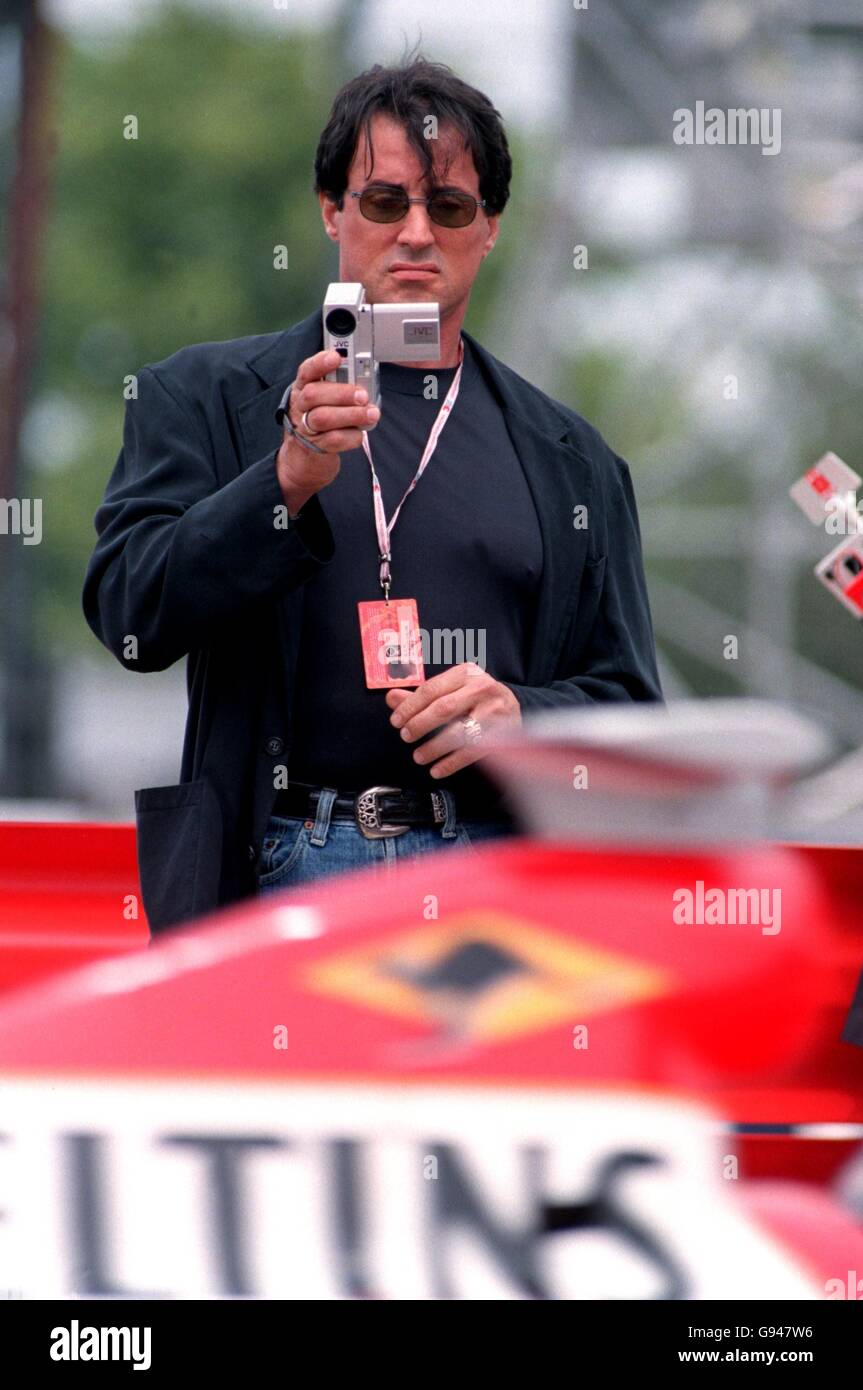 Formula One Motor Racing - British Grand Prix - Qualifying. Sylvester Stallone filming the cars in the pitlane Stock Photo