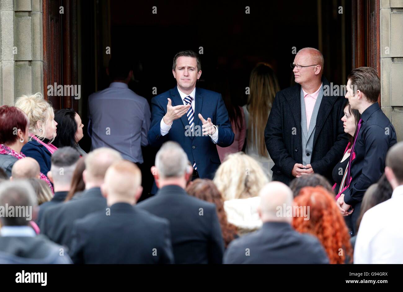 A sign language interpreter signs for deaf members of the congregation