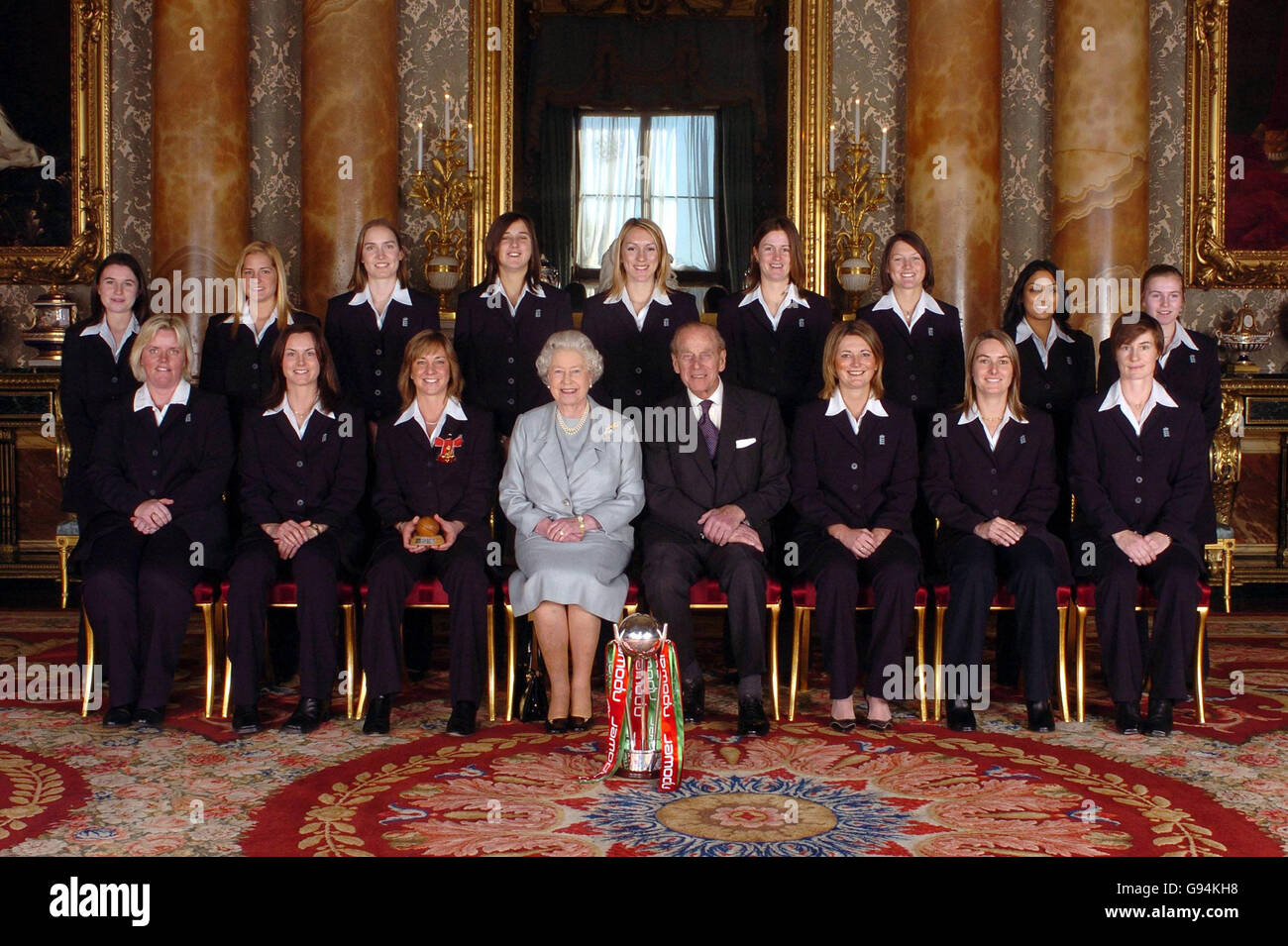 Members of England's women's 2005 Ashes winning Cricket team sit with Britain's Queen Elizabeth II and the Duke of Edinburgh in Buckingham Palace, London, Thursday February 9, 2006, after captain Clare Connor collected an OBE. Back row from left: Jo Watts, Katherine Brunt, Beth Morgan, Jenny Gunn, Rosalie Birch, Lydia Greenway, Arran Brindle, Isa Guha and Holly Colvin. Front row from left:Charlotte Dickenson, Laura Newton, captain Clare Connor, vice-captain Charlotte Edwards, Jane Smit and Clare Taylor. See PA story ROYAL Cricket. PRESS ASSOCIATION Photo. Photo credit should read: Johnny Stock Photo