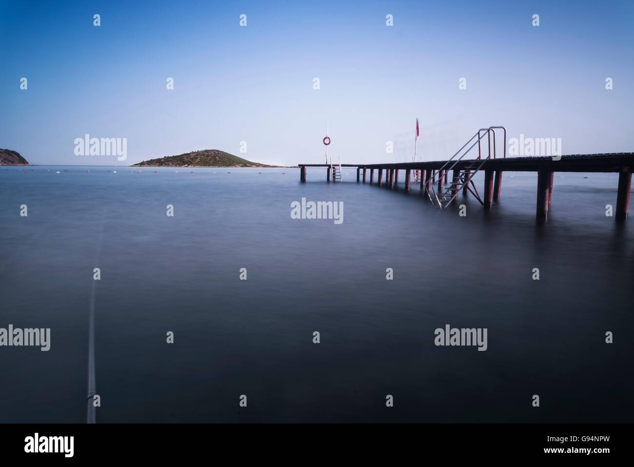 Single island and pier on the sea in Mugla Bodrum Gumusluk. Stock Photo
