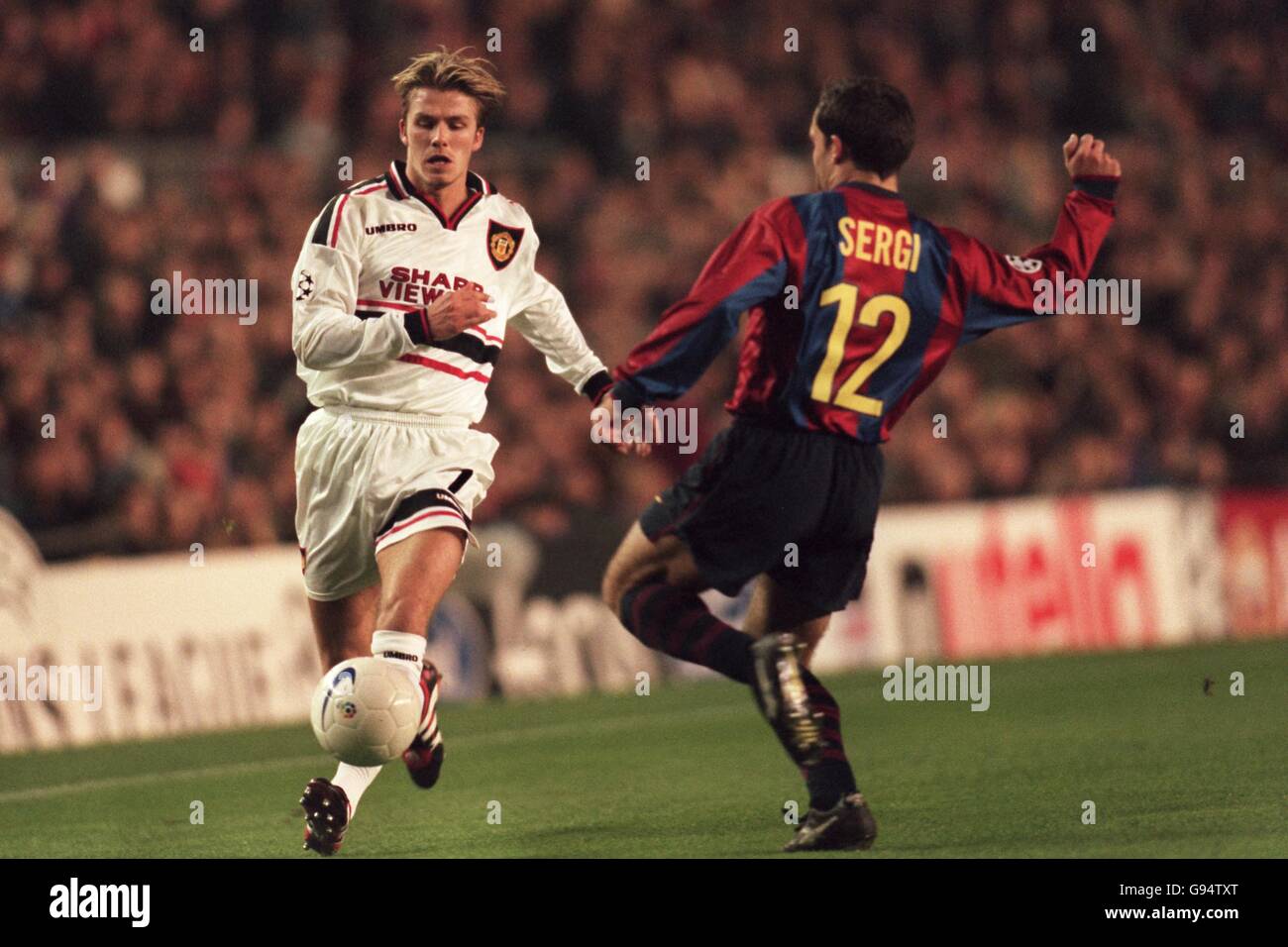 Barcelona's Sergi (right) moves across to tackle Manchester United's David Beckham (left) Stock Photo