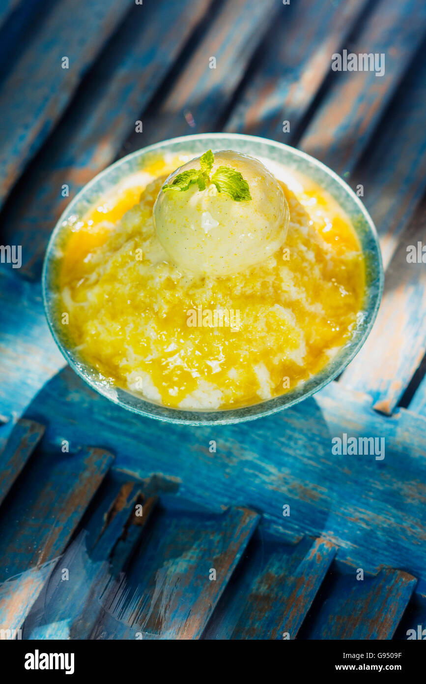 coconut milk sorbet with mango sauce and vanilla ice cream Stock Photo