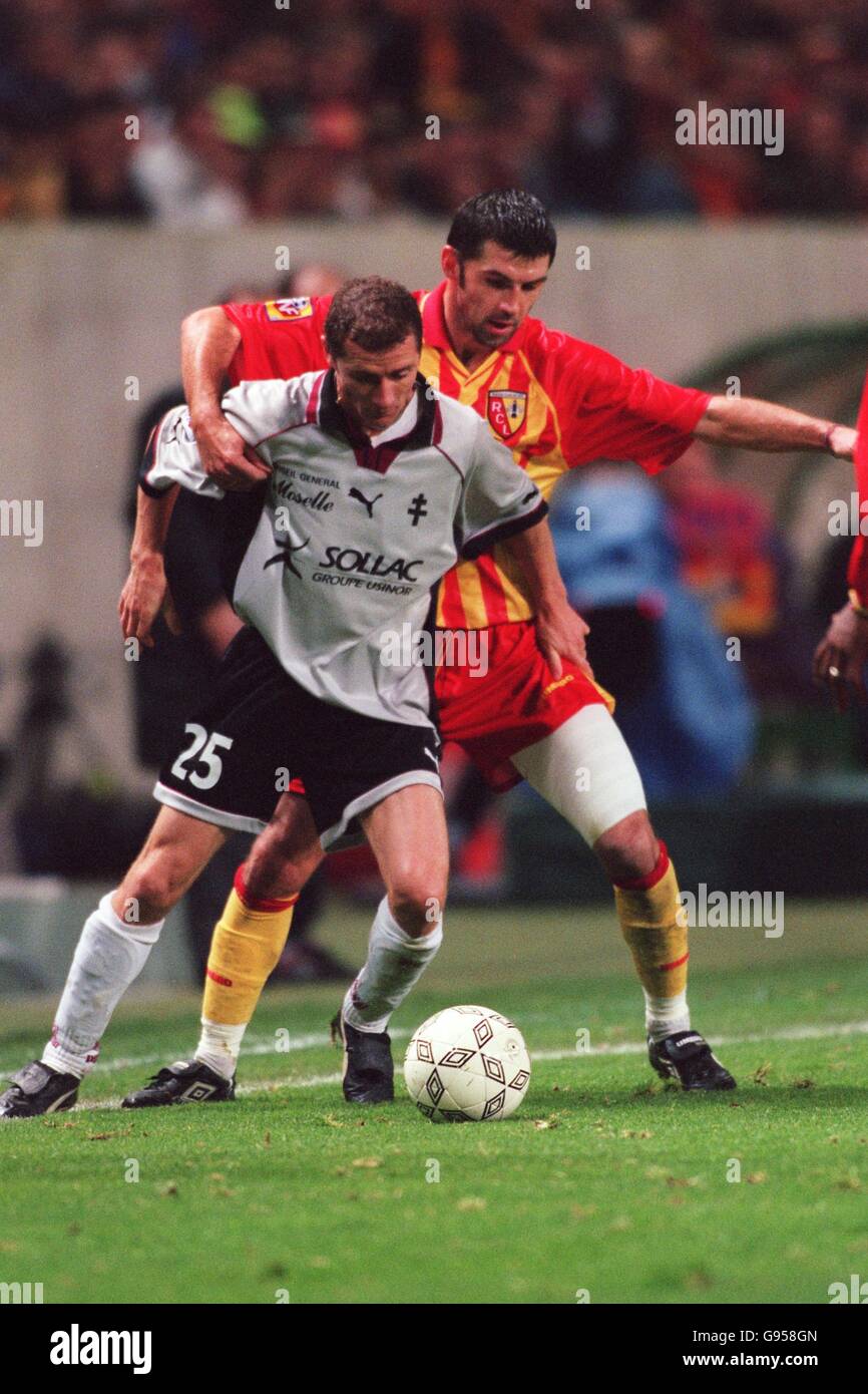 Metz's Danny Boffin (left) shields the ball from RC Lens's Eric Sikora (right) Stock Photo