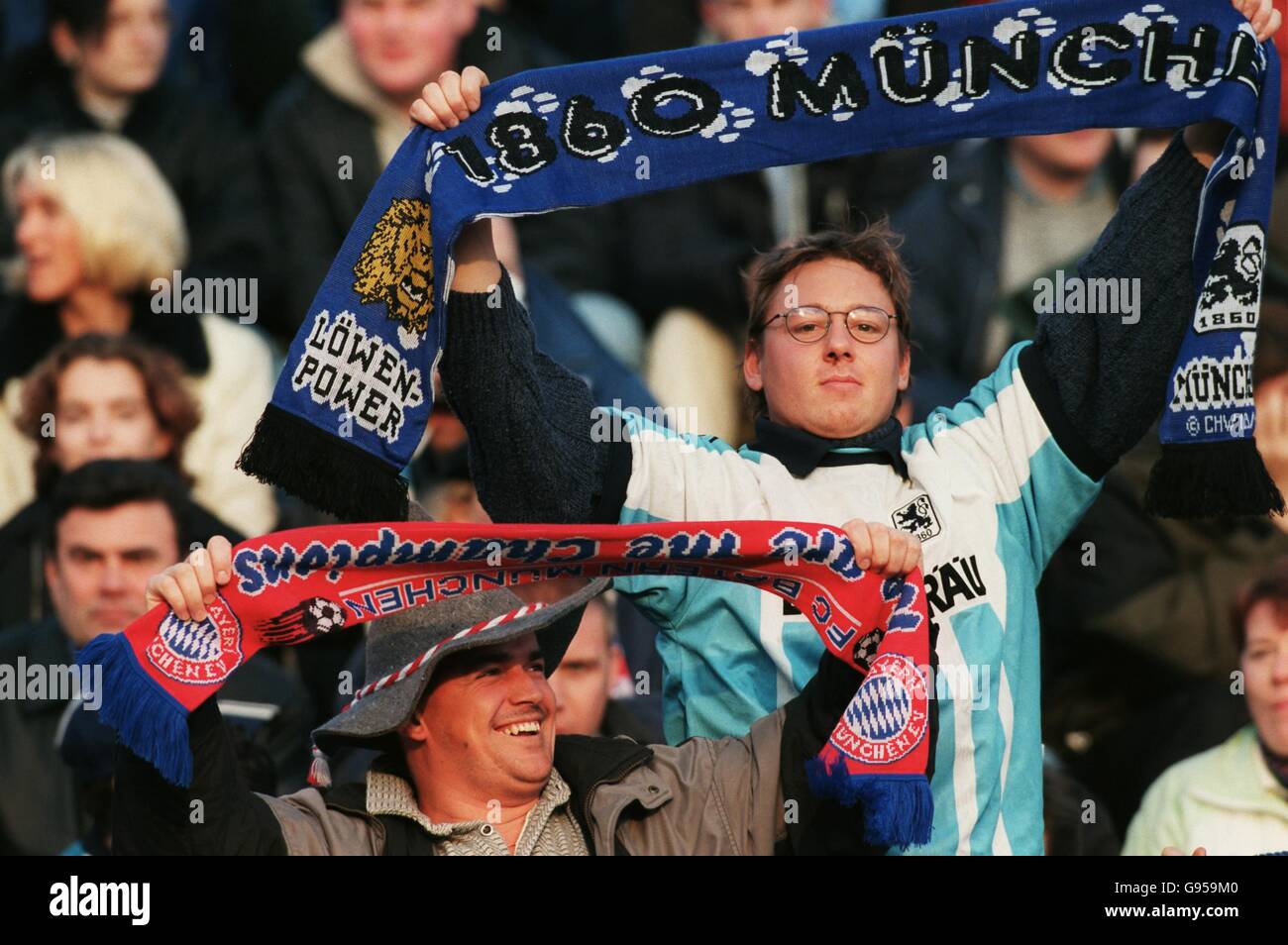 1860 Munich and Bayern Munich fans sitting together in the stands Stock Photo