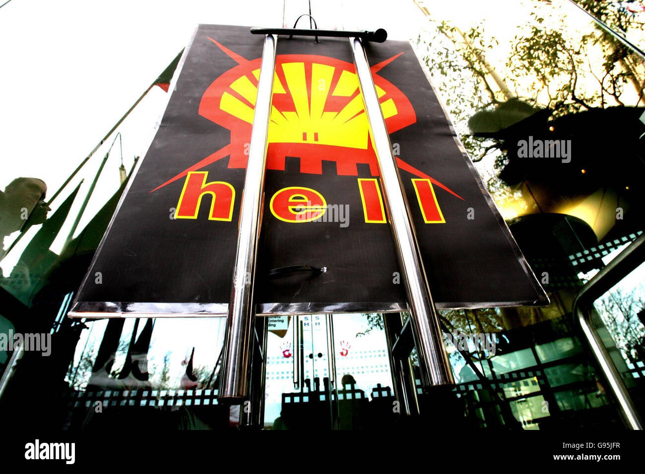 Members of the shell to sea campaign are reflected in office windows in ...