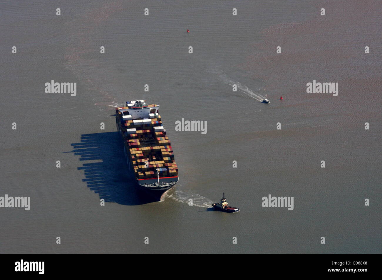 Aerial view of ship being tugged to port at Felixstowe Stock Photo