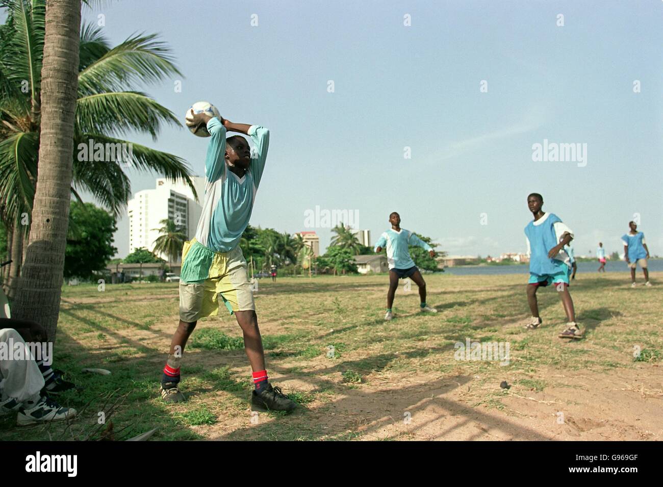 Nigerian takes throw in in the shadow of palm tree hires stock