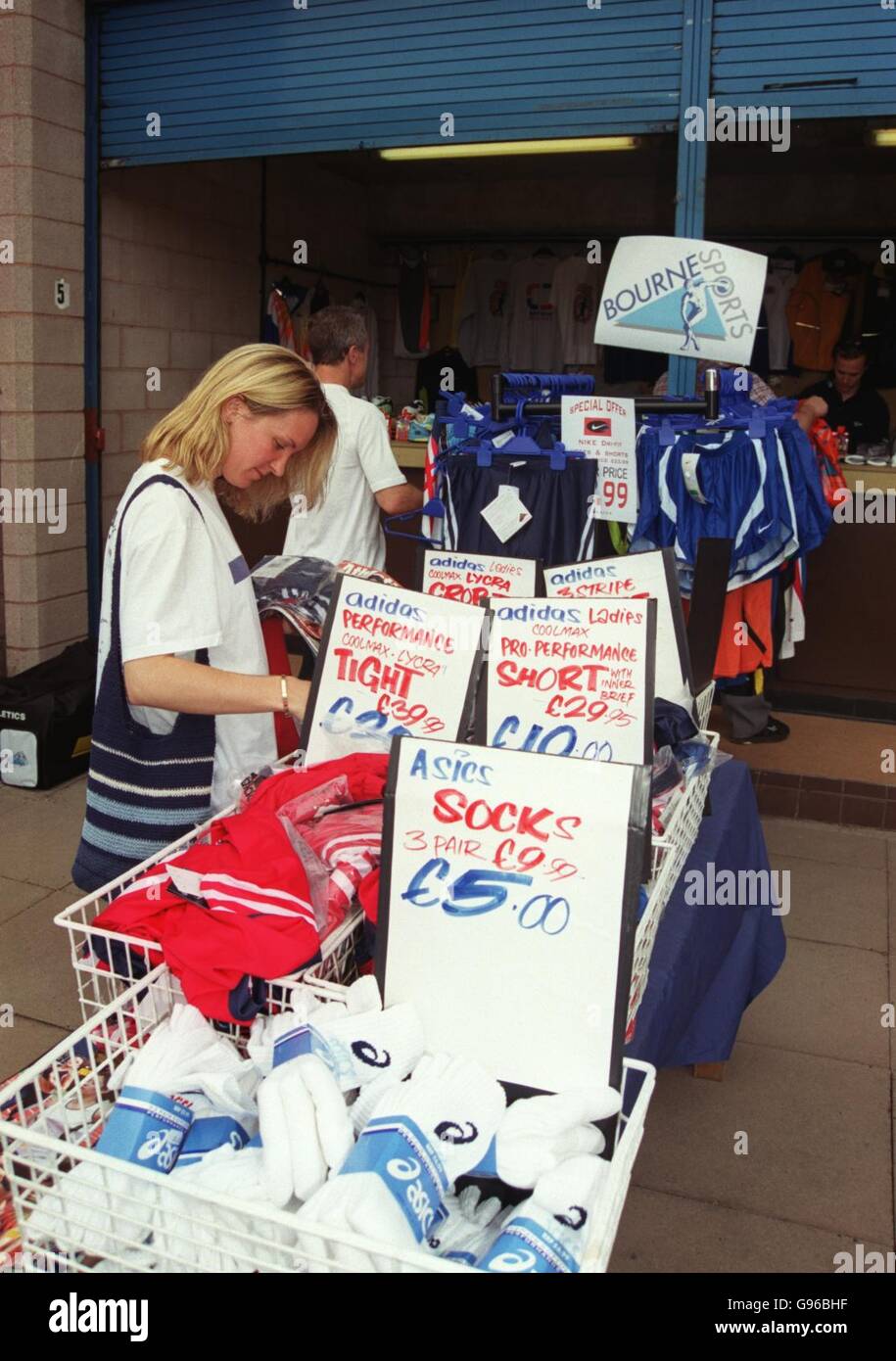 Spectators browse through a discounted clothes stall at the meeting