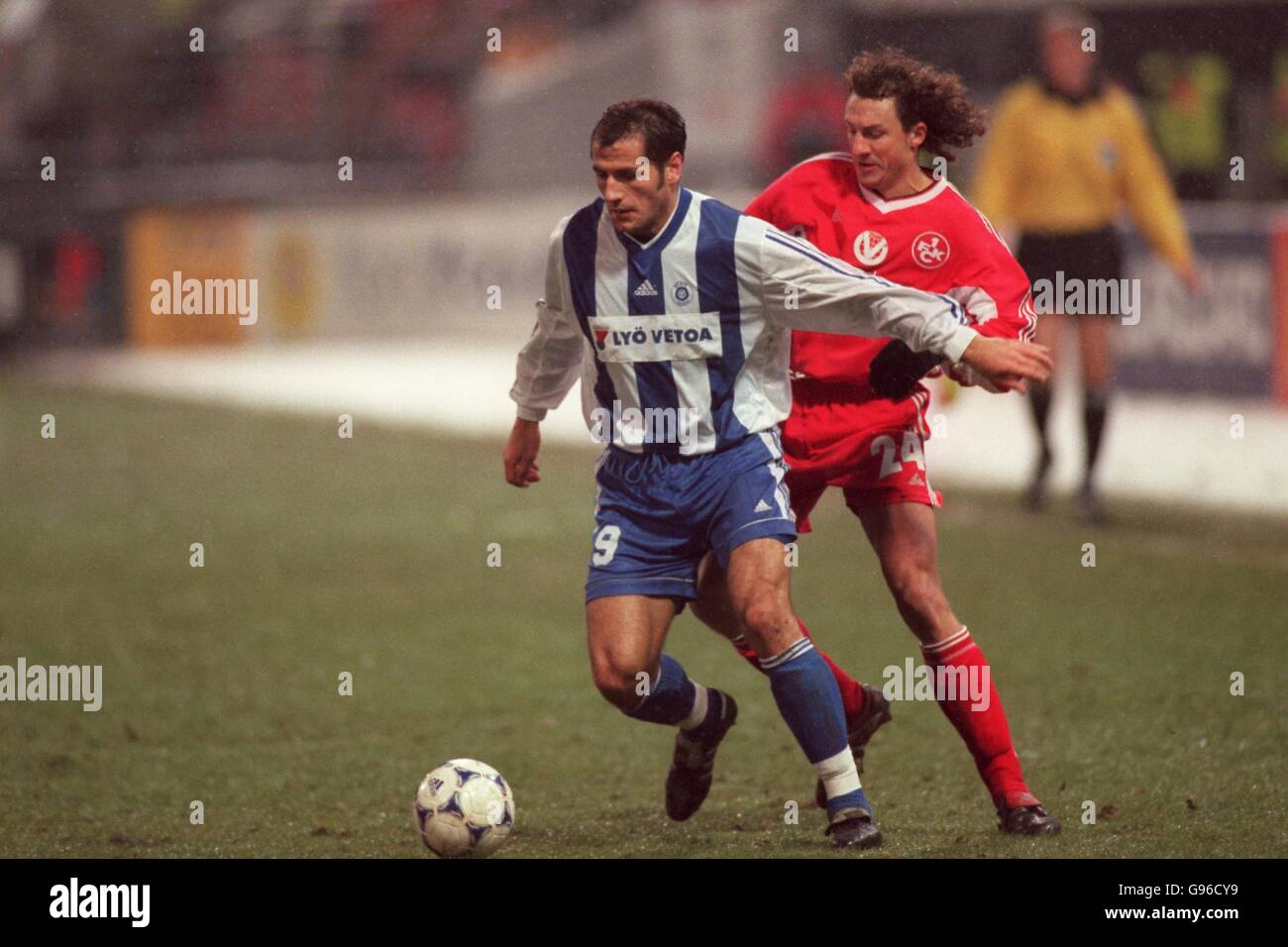 HJK Helsinki's Shefki Kuqi (left) shields the ball from Kaiserslautern's Harry Koch (right) Stock Photo