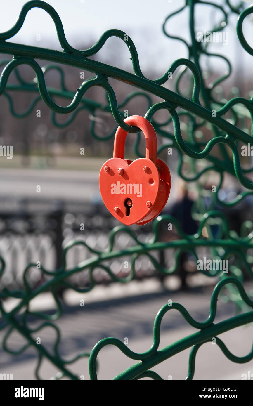 Love symbol. Red closed padlock as heart hanging on bridge Stock Photo ...