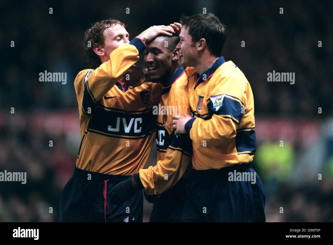 Ray Parlour and Stephen Hughes congratulate Nicolas Anelka on scoring for Arsenal Stock Photo