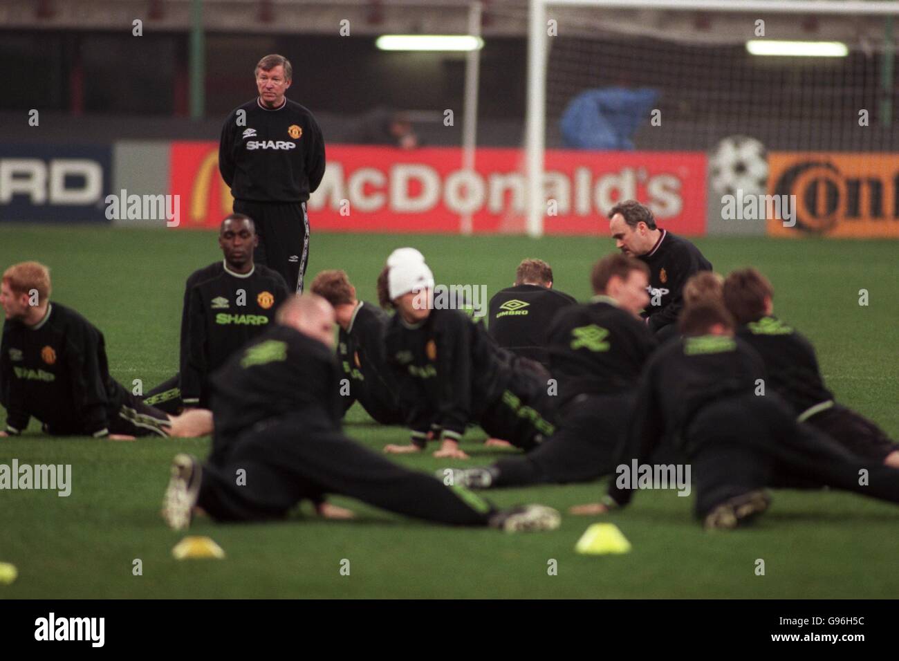 Manchester United manager Alex Ferguson keeps an eye on his team as