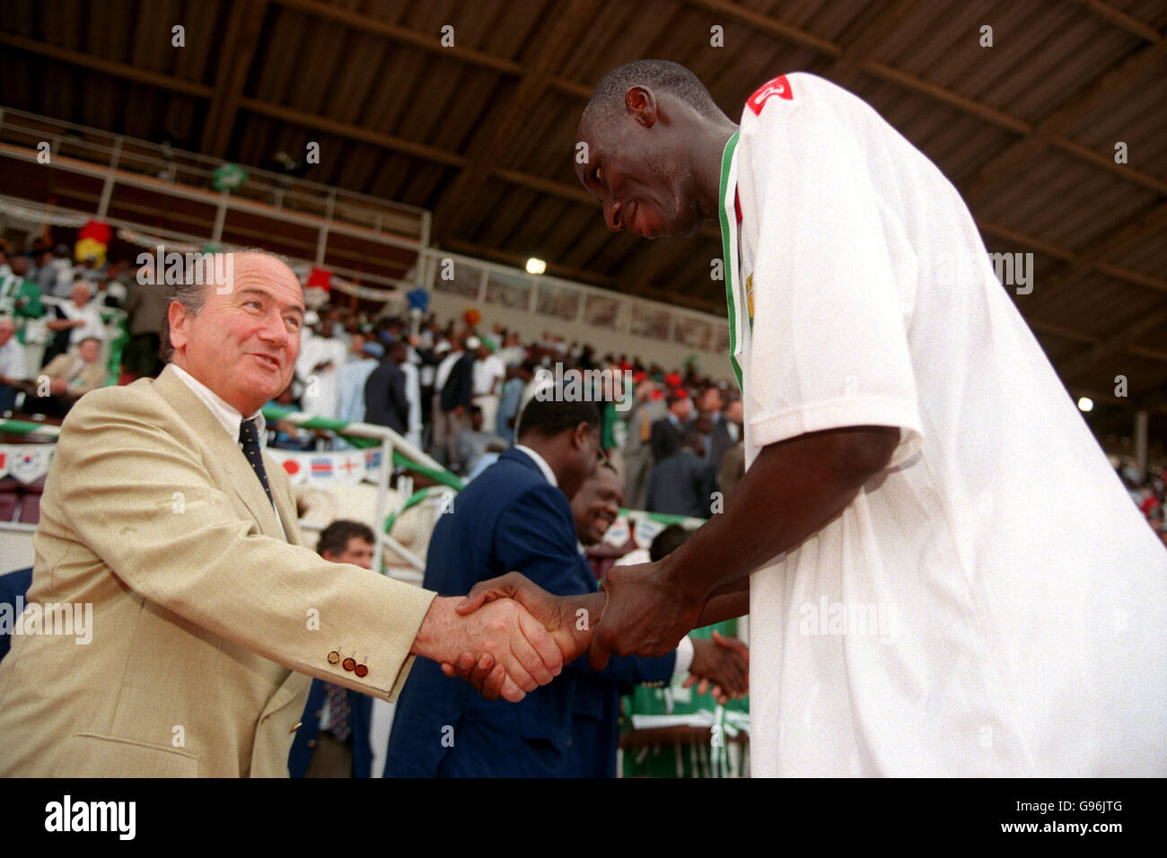 FIFA President Sepp Blatter (left) congratulates one of the Mali players on their victory and third place finish in the tournament Stock Photo