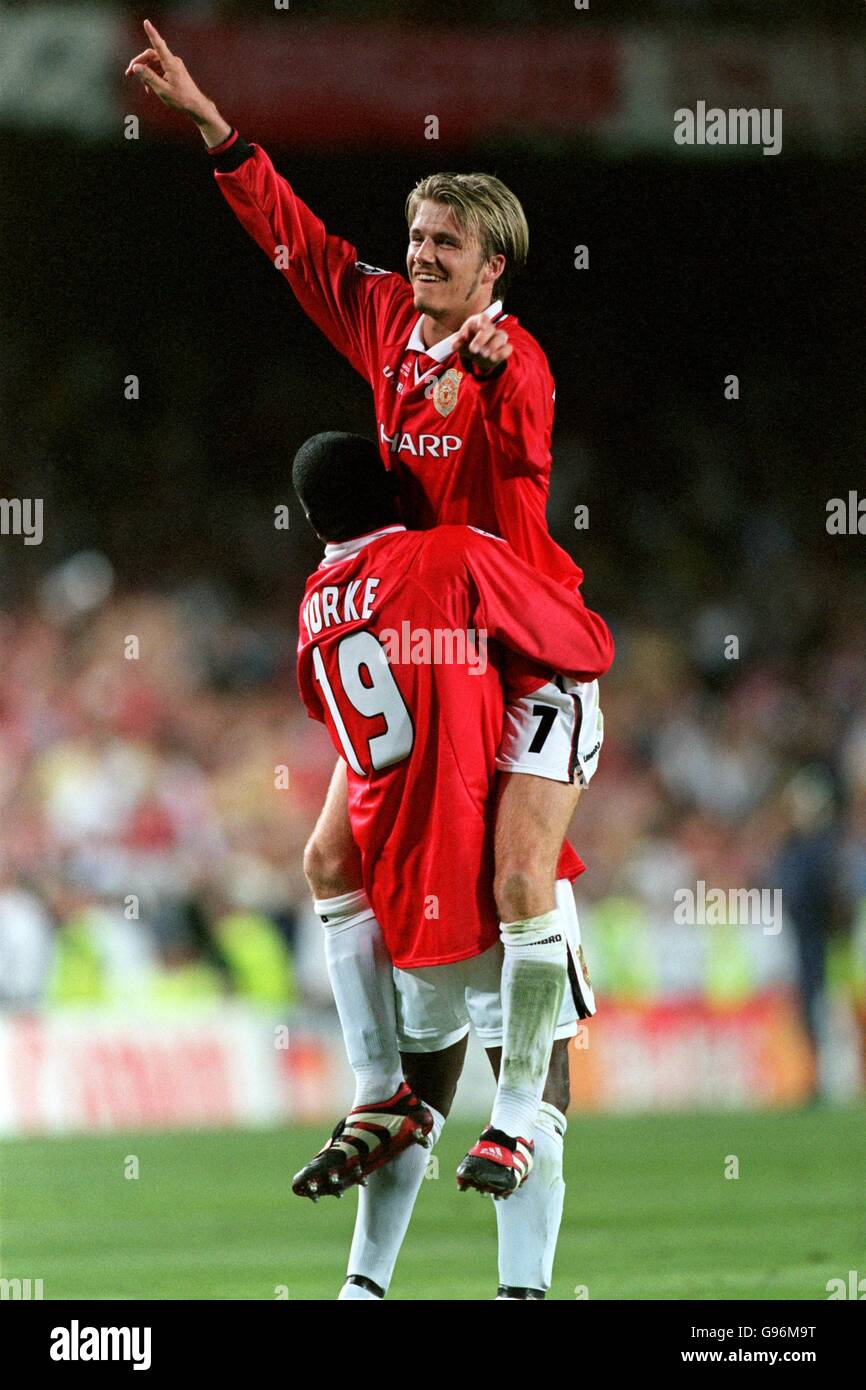 Manchester United's Dwight Yorke (left) gives a jubilant David Beckham (right) a lift after their last minute triumph Stock Photo