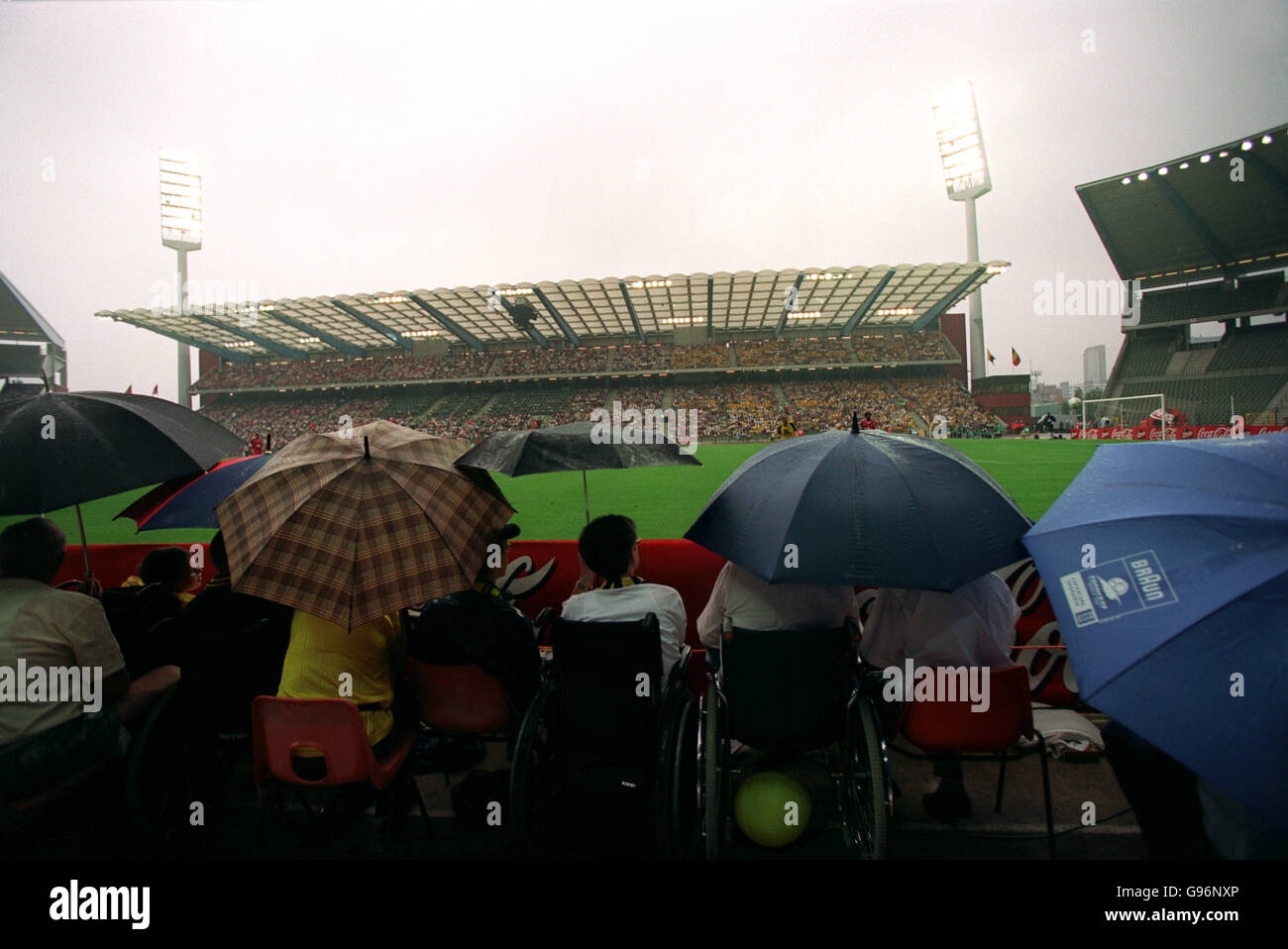 General view stadium umbrella raining football High Resolution Stock