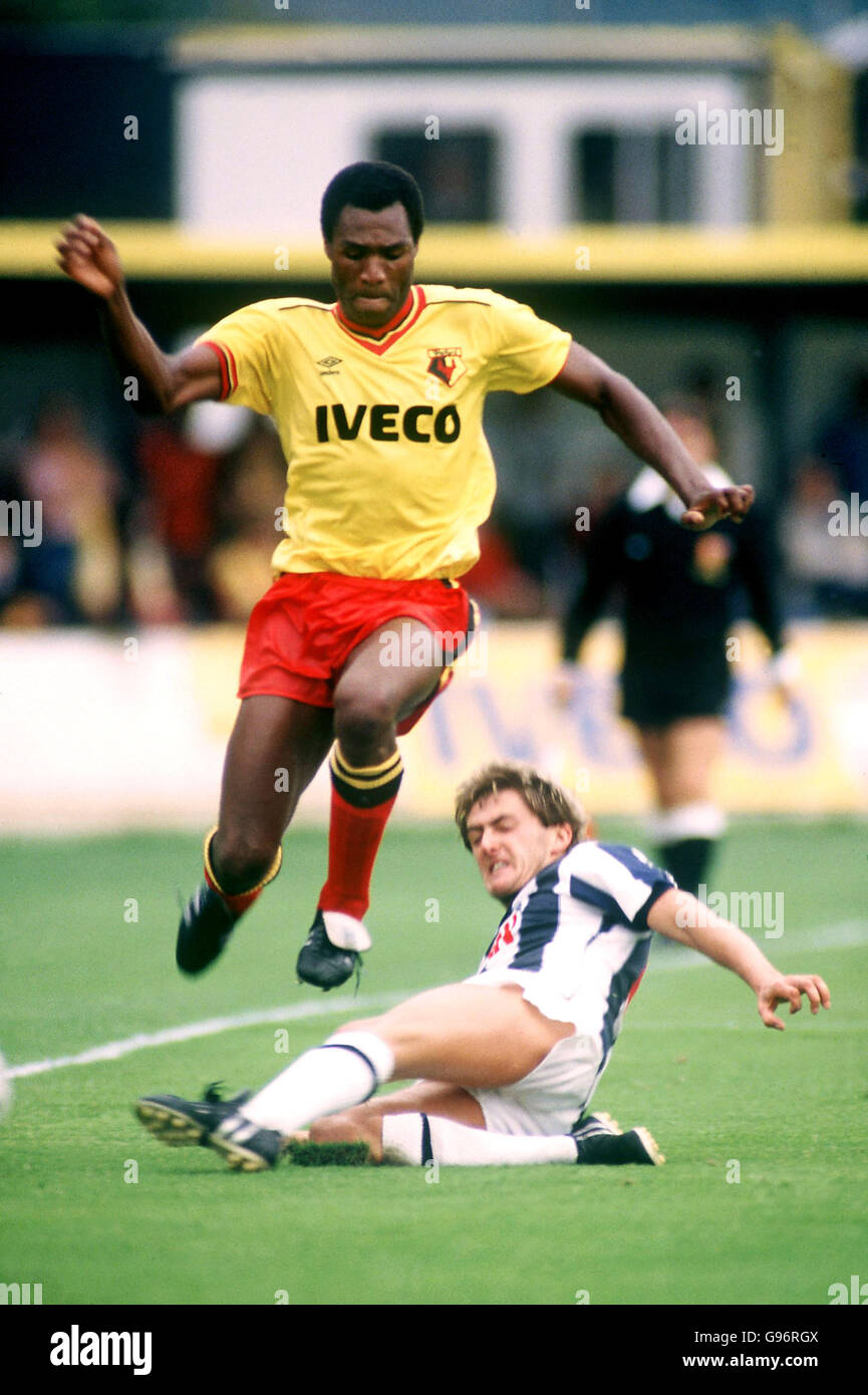 Watford's Luther Blissett (left) leaps a challenge from West Bromwich Albion's Gary Owen (right) Stock Photo