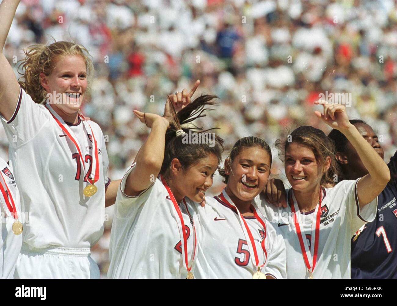USA's Mia Hamm (far right), celebrates winning the Womens World Cup with teamates (R-L), Tiffany Roberts,Lorrie Fair and Cindy Parlow. Stock Photo