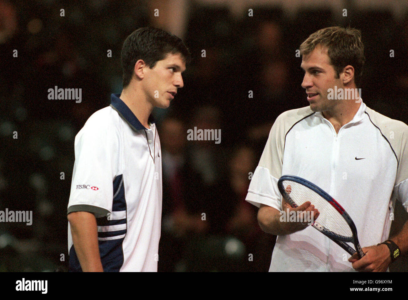 Tim Henman (left) gives Greg Rusedski (right) a reproachful stare during their match against Piet Norval and Keith Ullyett Stock Photo