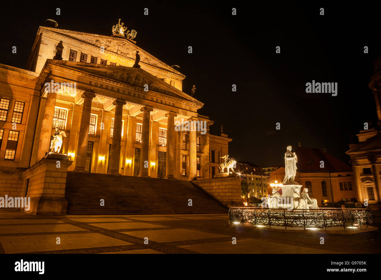 Berlin Konzerthaus (concert house) and statue of Friedrich Schiller, Gendarmenmarkt, shot at night. Stock Photo