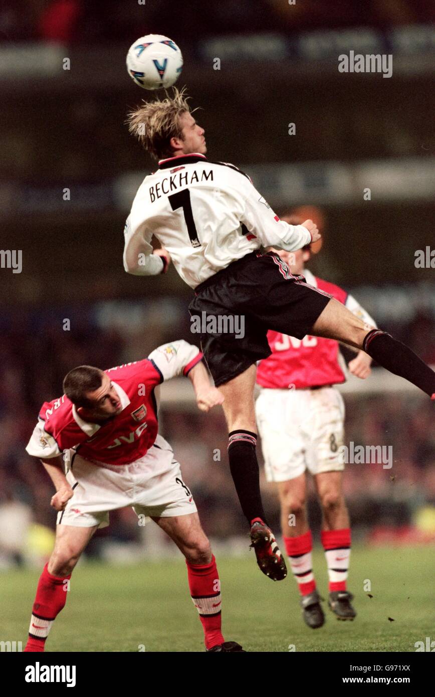 Soccer - AXA F.A. CUP - Semi-final Match - Manchester United v Arsenal. Manchester United's David Beckham jumps for a high ball with Arsenal's Nigel Winterburn. Stock Photo