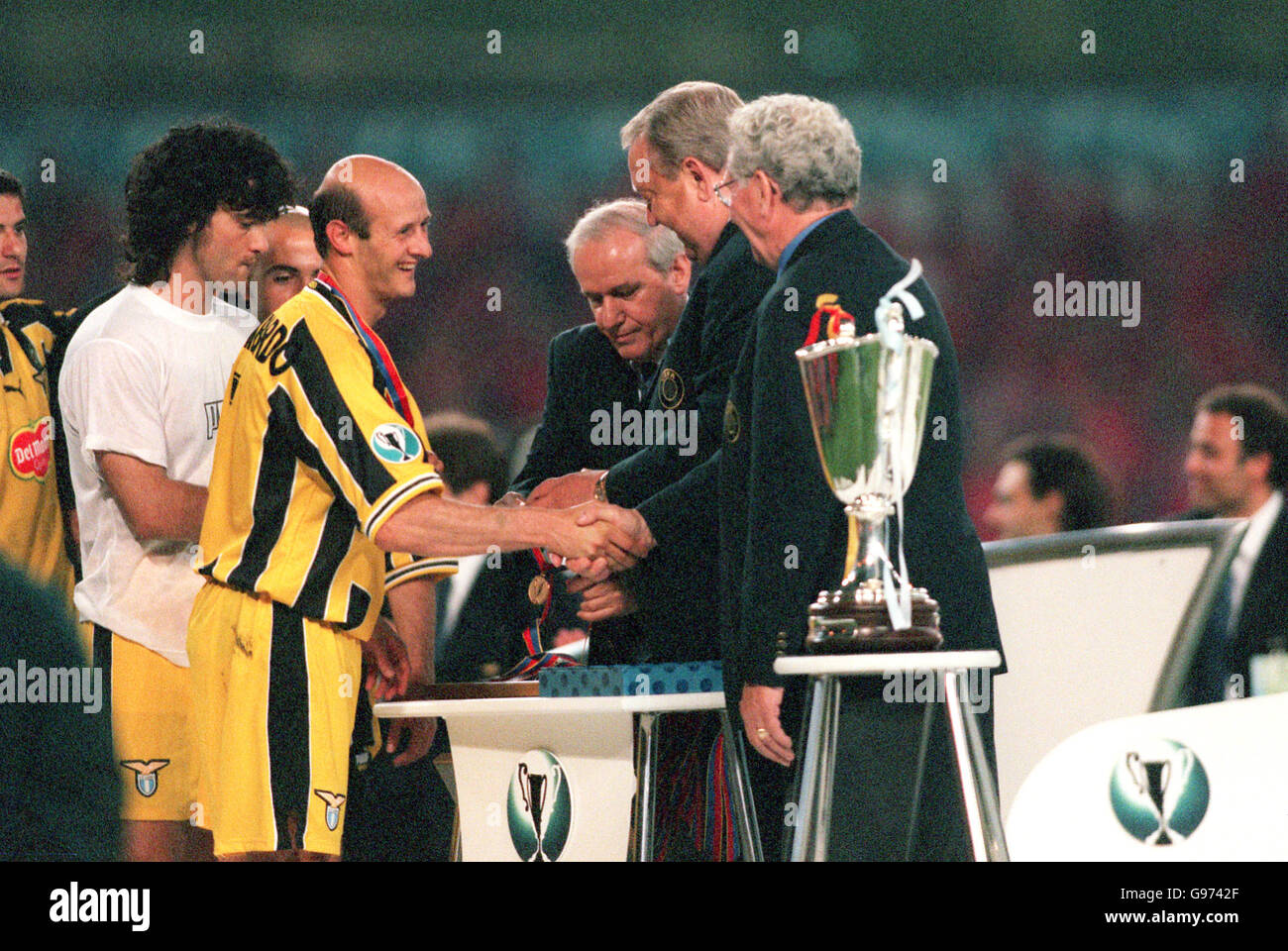 Lazio's Attilio Lombardo (left) receives his winners' medal from UEFA President Lennart Johansson (second right) Stock Photo
